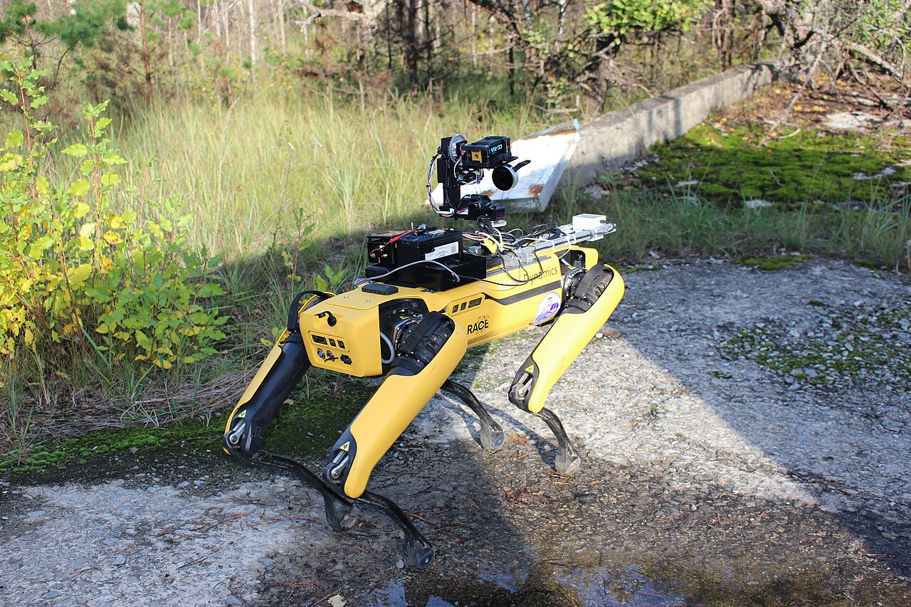 A four-legged robot carrying a sensor payload outdoors