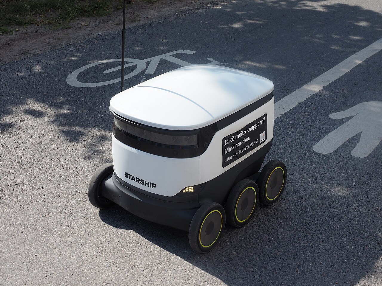 A six-wheeled autonomous delivery robot on a bike path